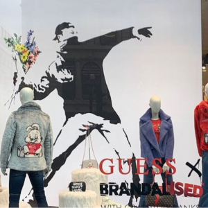banksy encourages fans to shoplift after claiming guess store stole his artwork for a campaign